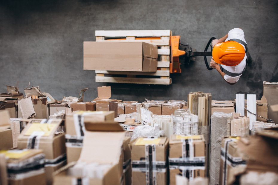 young man working at warehouse with boxes